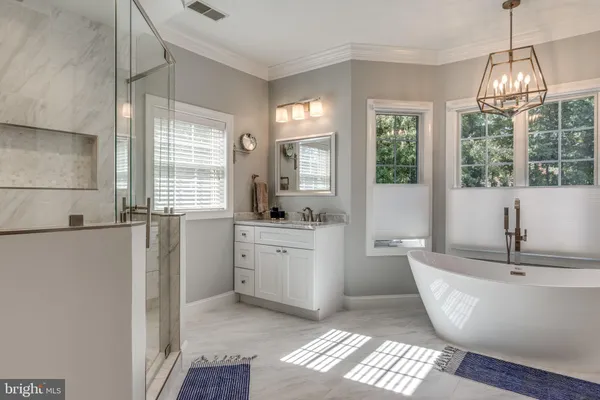 a bathroom with a tub sink and mirror