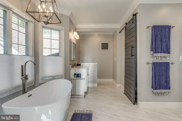 a bathroom with a tub shower and sink