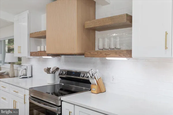 a kitchen with a sink a stove and cabinets