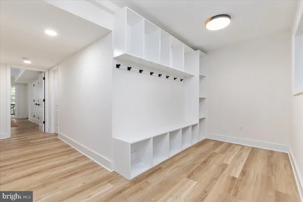 a view of an empty room with wooden floor