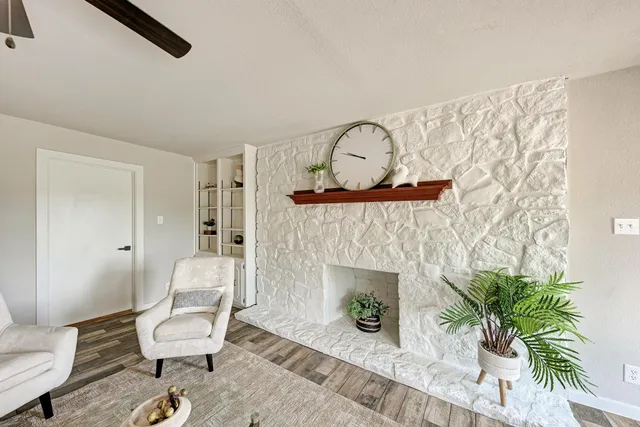 a kitchen with a sink dishwasher a stove and white cabinets with wooden floor