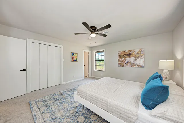 a bedroom with a bed and a lamp