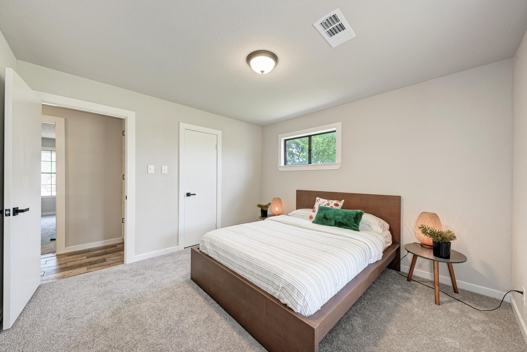 2365 Hackberry Road Salado, TX 76571 - Photo 27 of 40 a bedroom with a bed and a lamp