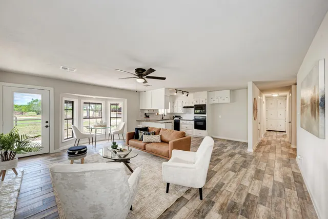 a living room with furniture and a fireplace