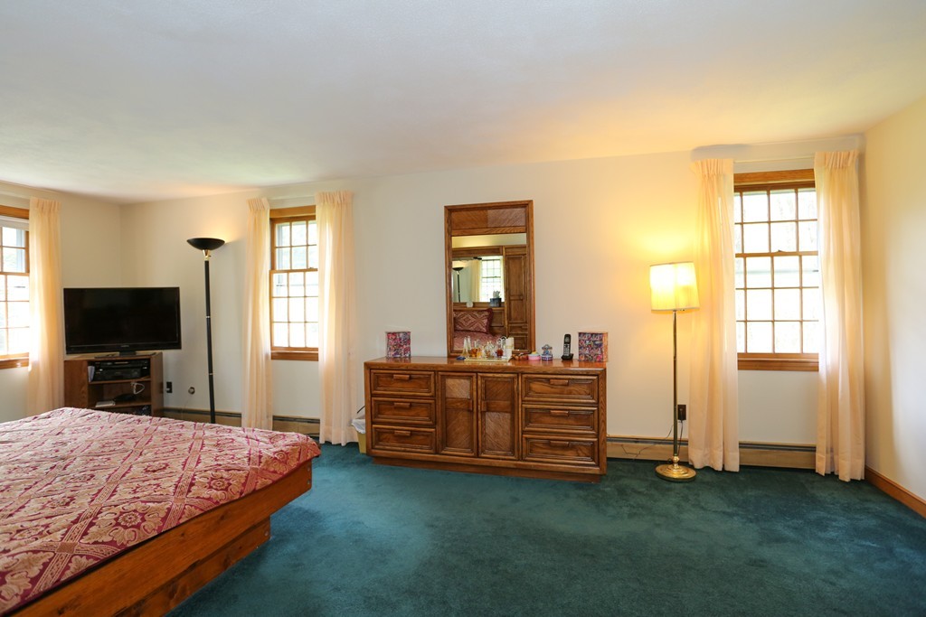 28 Middle Road Sudbury, MA 01776 - Photo 18 of 24 a bed room with a bed and a television
