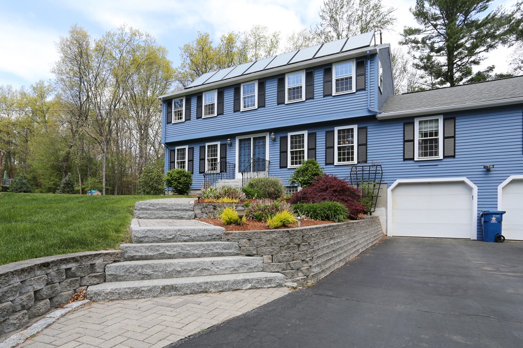 28 Middle Road Sudbury, MA 01776 - Photo 2 of 24 a front view of a house with a garden and yard
