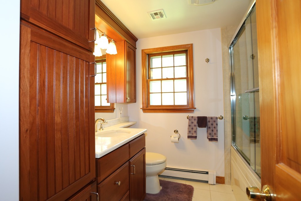 28 Middle Road Sudbury, MA 01776 - Photo 24 of 24 a bathroom with a sink a toilet and shower