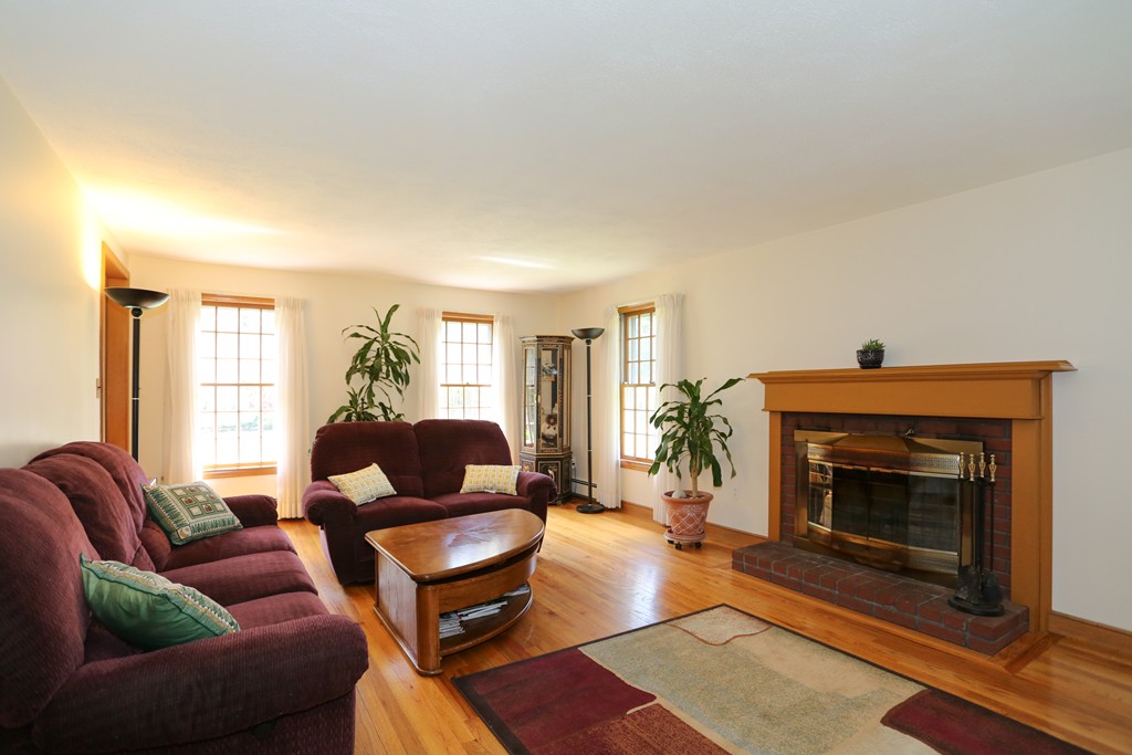 28 Middle Road Sudbury, MA 01776 - Photo 9 of 24 a living room with furniture and a fireplace