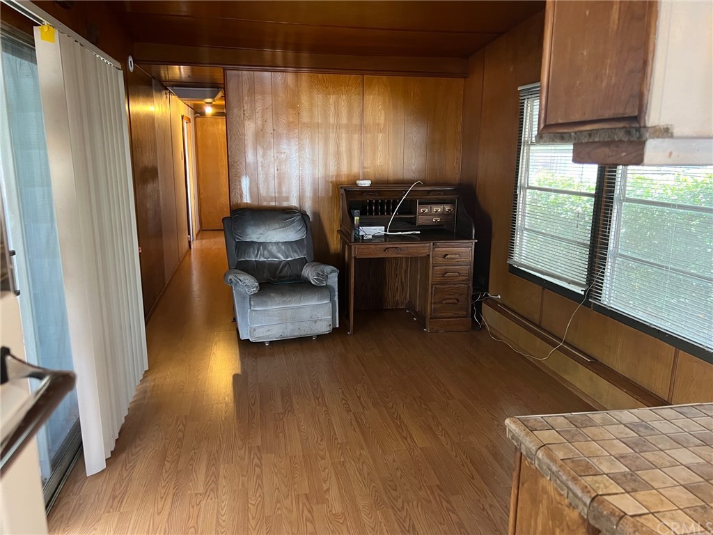 13645 5th Street, Unit 35 Yucaipa, CA 92399 - Photo 15 of 22 a view of hallway with couches and wooden floor