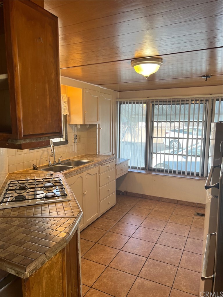 13645 5th Street, Unit 35 Yucaipa, CA 92399 - Photo 7 of 22 a kitchen with a sink a stove cabinets and a window