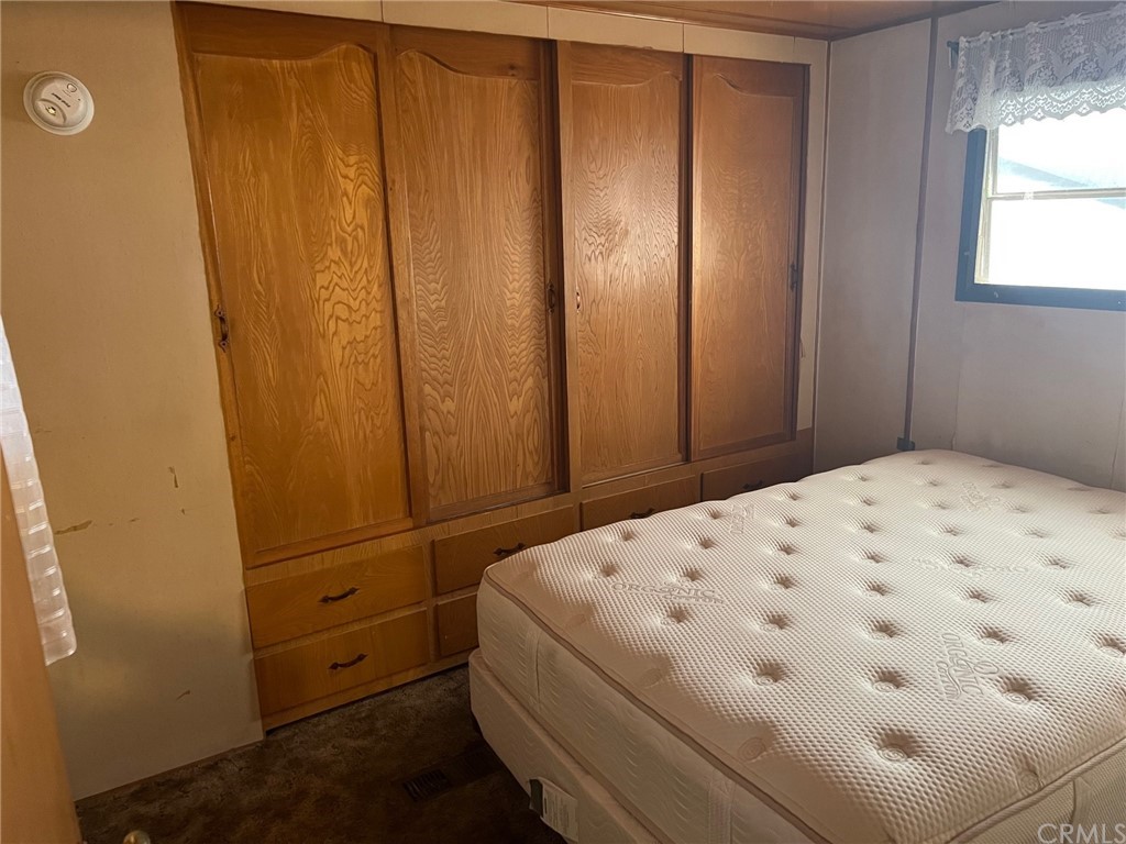 13645 5th Street, Unit 35 Yucaipa, CA 92399 - Photo 10 of 22 a bedroom with a bed and a window