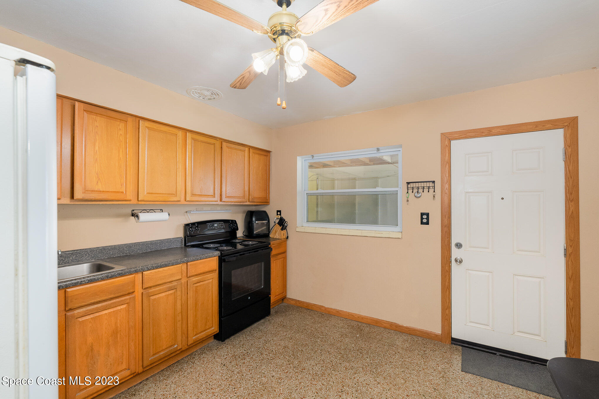109 Cherry Street Melbourne, FL 32901 - Photo 2 of 31 a kitchen with granite countertop cabinets stainless steel appliances and a window