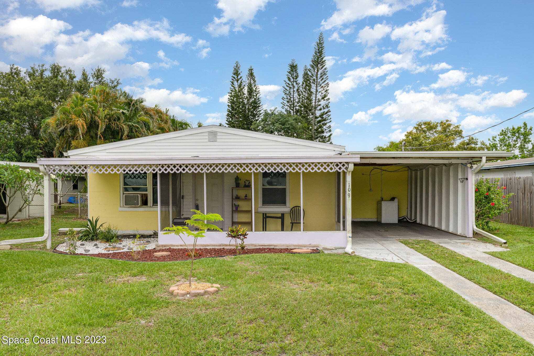 109 Cherry Street Melbourne, FL 32901 - Photo 22 of 31 a front view of a house with a garden and porch