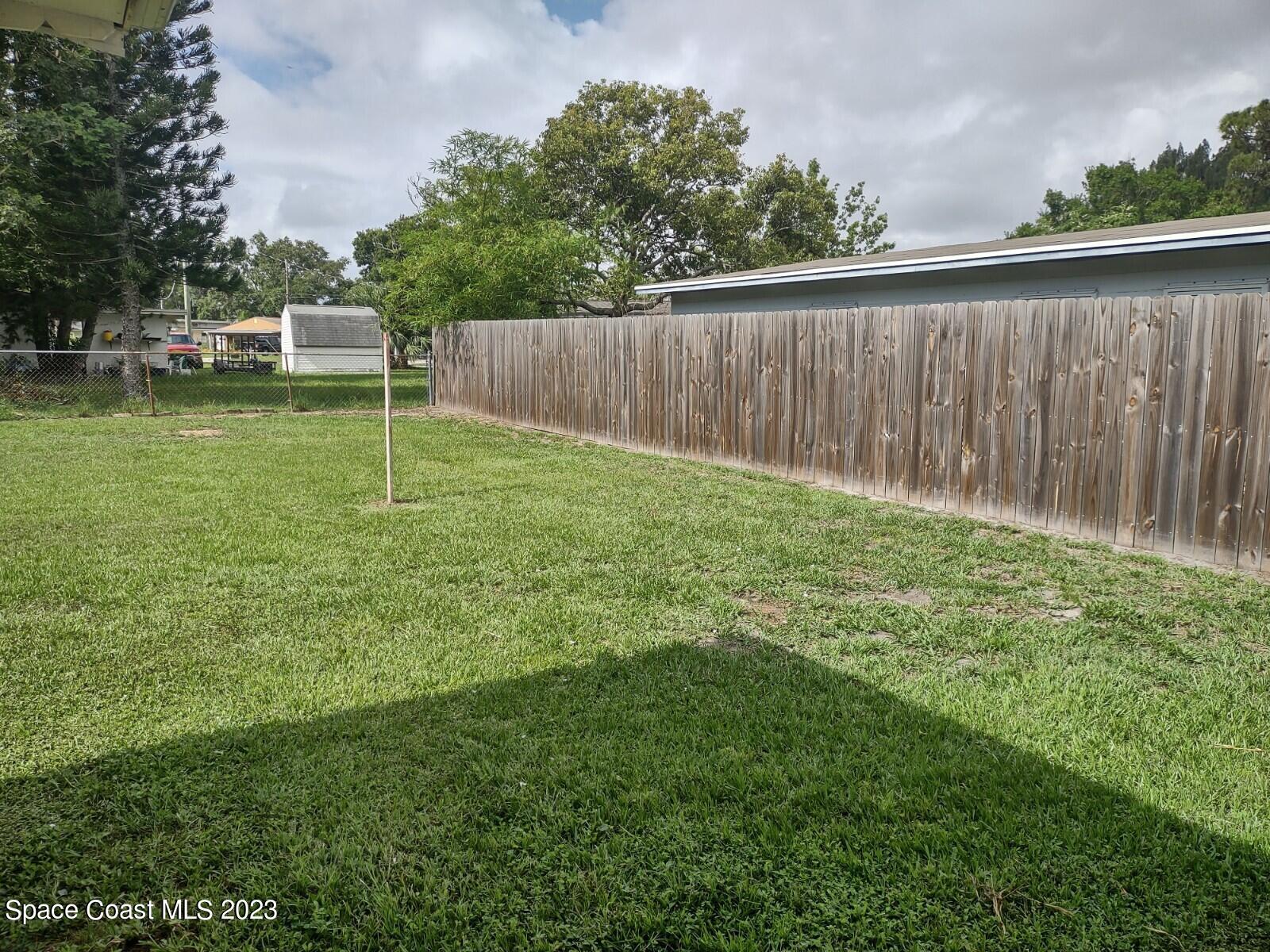 109 Cherry Street Melbourne, FL 32901 - Photo 23 of 31 a view of a backyard with a garden and entertaining space