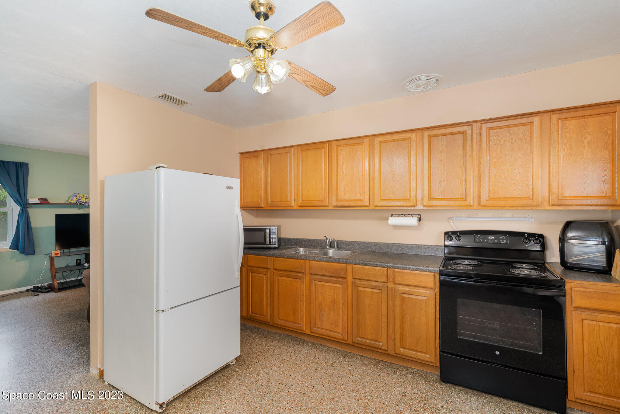 109 Cherry Street Melbourne, FL 32901 - Photo 3 of 31 a kitchen with a refrigerator stove and sink