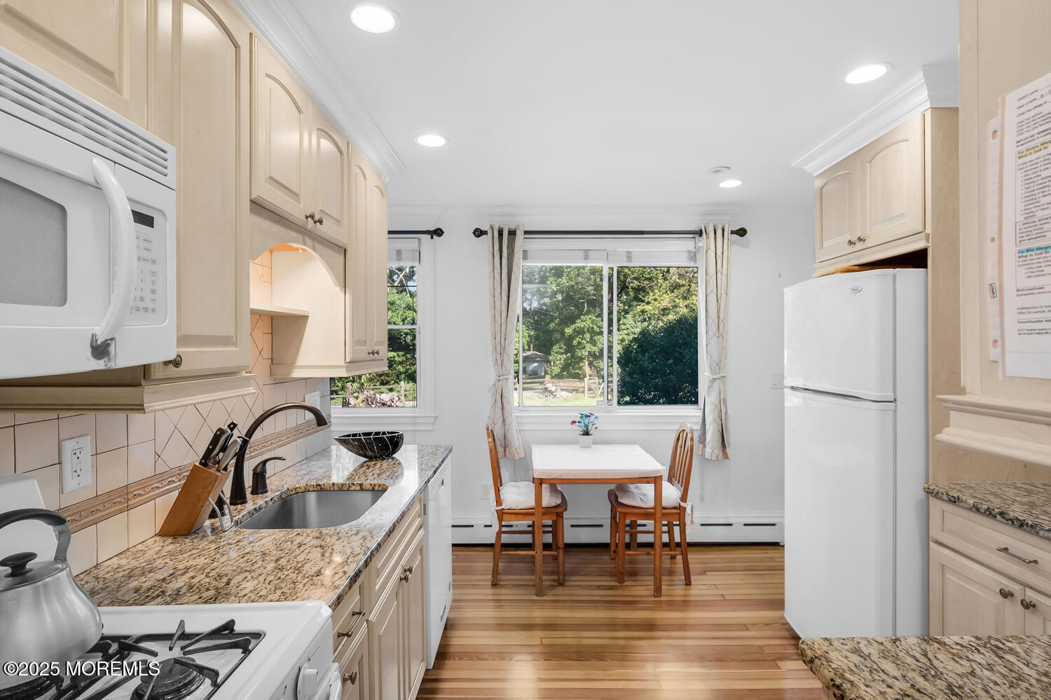 120 Bowne Road Middletown, NJ 07716 - Photo 13 of 25 a kitchen with stainless steel appliances granite countertop a refrigerator a sink a stove and a dining table with wooden floor
