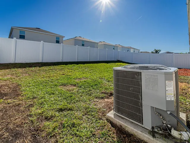 an aerial view of multiple houses with a yard