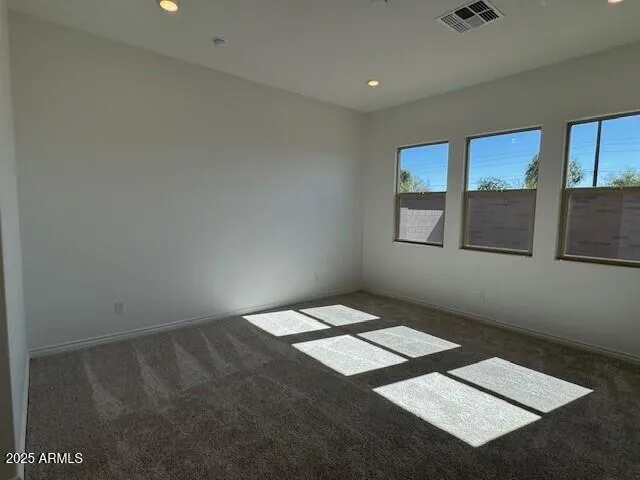 a bedroom with bed and a painting on the wall