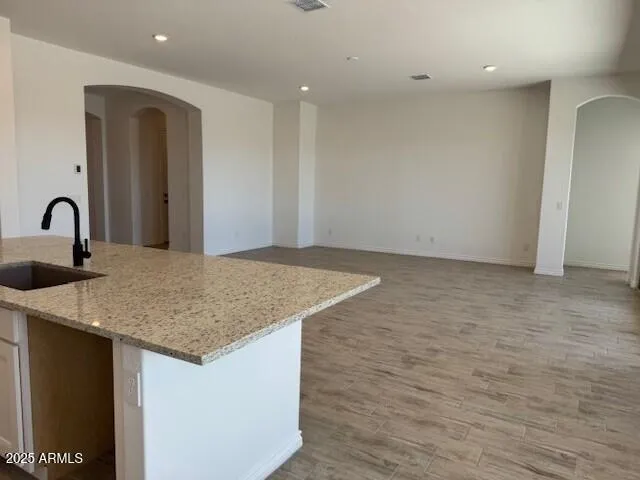 a kitchen with a sink and a mirror