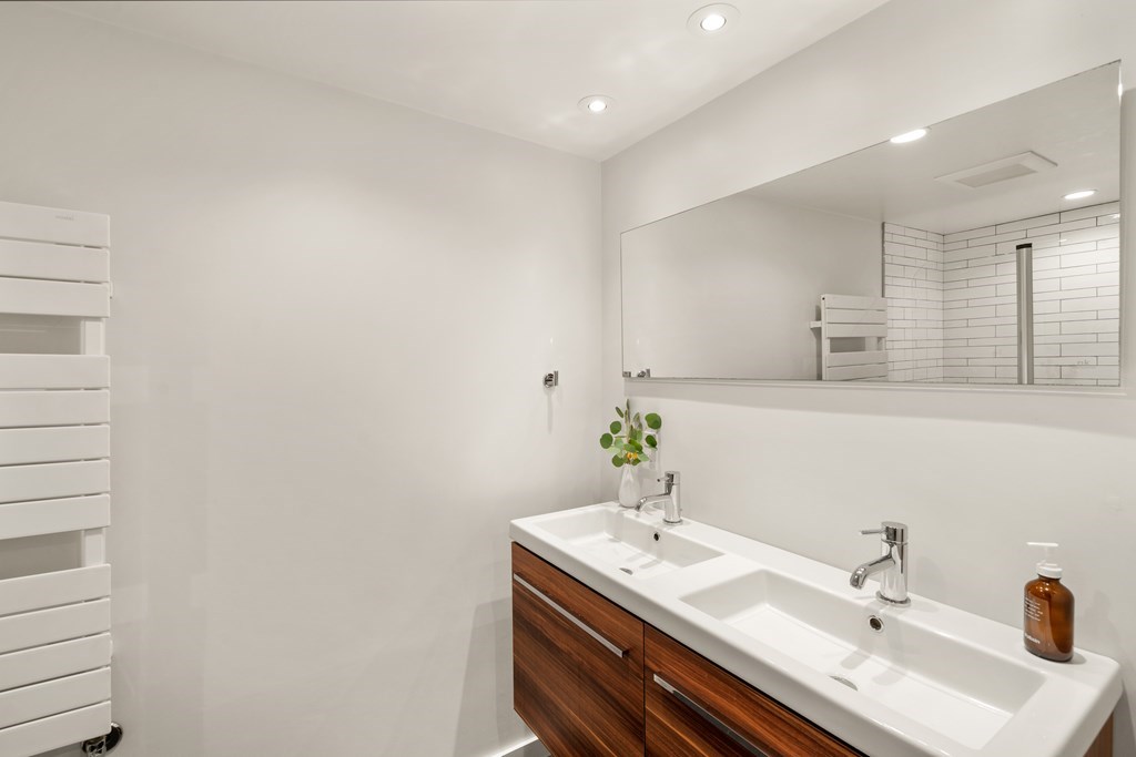 5 Auburn Street, Unit 1 Boston, MA 02129 - Photo 13 of 25 a bathroom with a granite countertop sink and a mirror