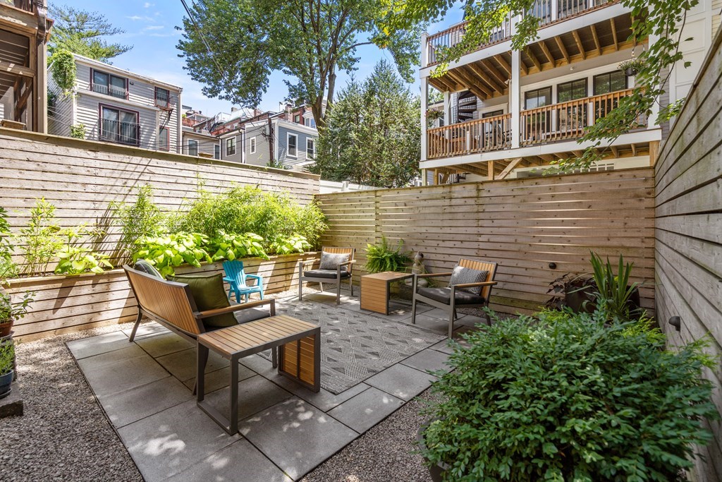 5 Auburn Street, Unit 1 Boston, MA 02129 - Photo 17 of 25 a view of a patio with table and chairs and potted plants