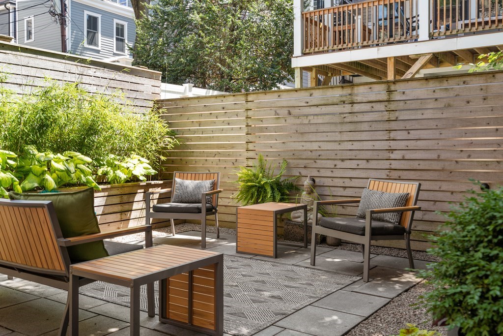 5 Auburn Street, Unit 1 Boston, MA 02129 - Photo 18 of 25 a view of a patio with table and chairs and potted plants