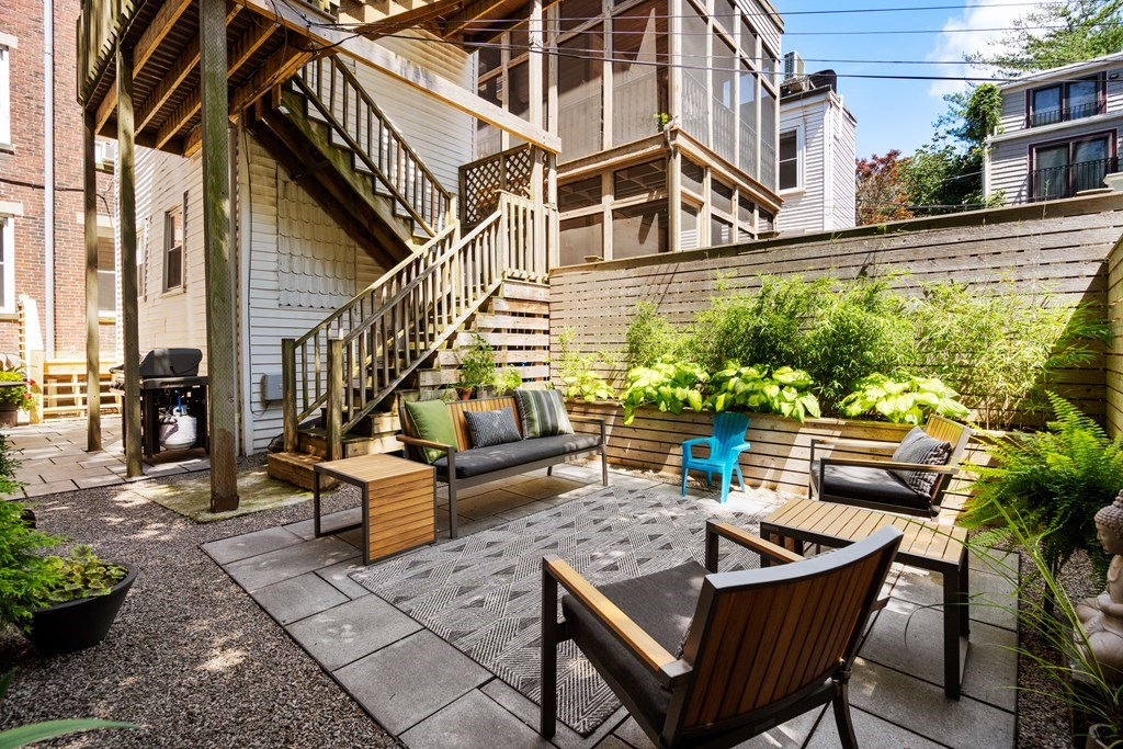 5 Auburn Street, Unit 1 Boston, MA 02129 - Photo 20 of 25 a view of a patio with couches table and chairs and potted plants