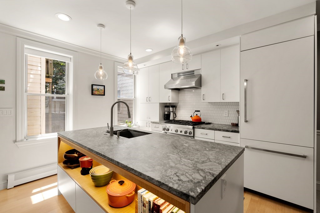 5 Auburn Street, Unit 1 Boston, MA 02129 - Photo 2 of 25 a kitchen with stainless steel appliances granite countertop a sink a refrigerator and a stove