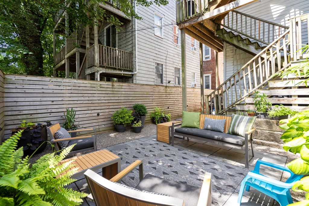 5 Auburn Street, Unit 1 Boston, MA 02129 - Photo 21 of 25 a view of backyard with outdoor seating and plants