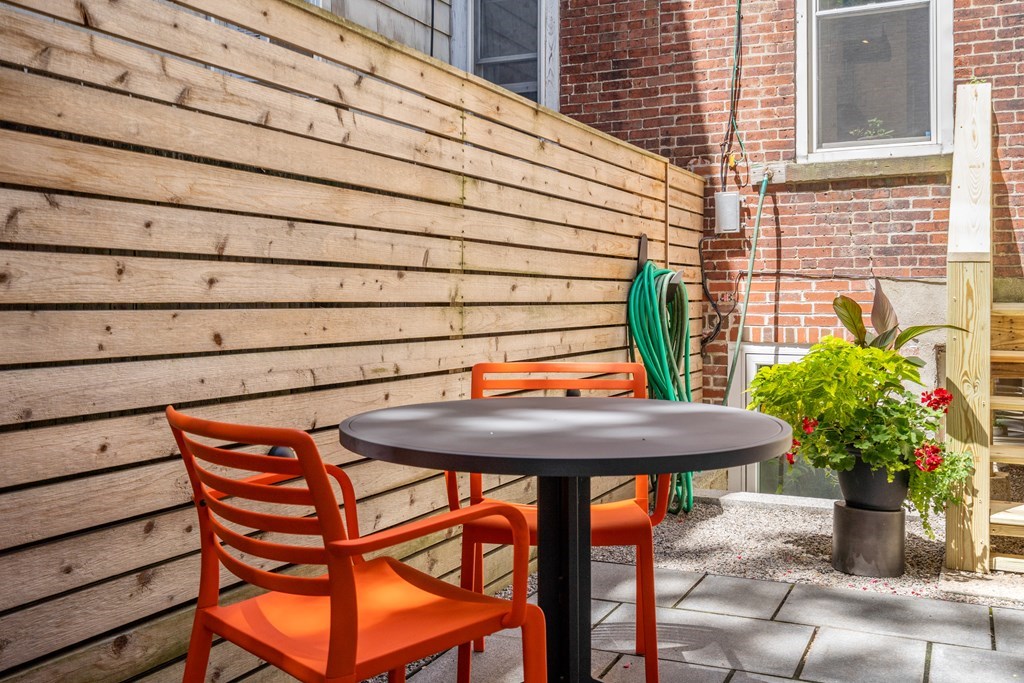5 Auburn Street, Unit 1 Boston, MA 02129 - Photo 22 of 25 a backyard of a house with table and chairs