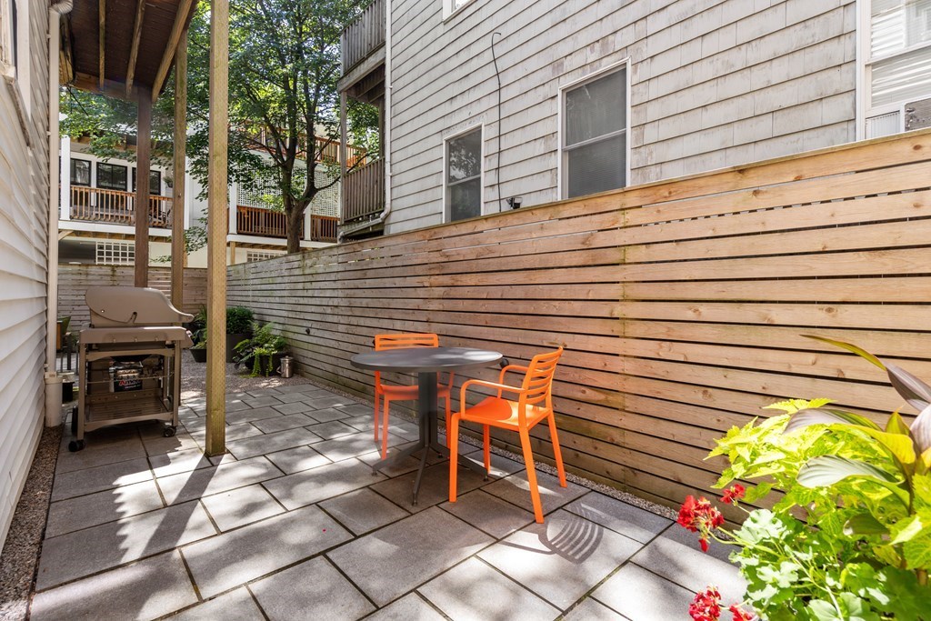 5 Auburn Street, Unit 1 Boston, MA 02129 - Photo 23 of 25 a view of a patio with table and chairs and potted plants