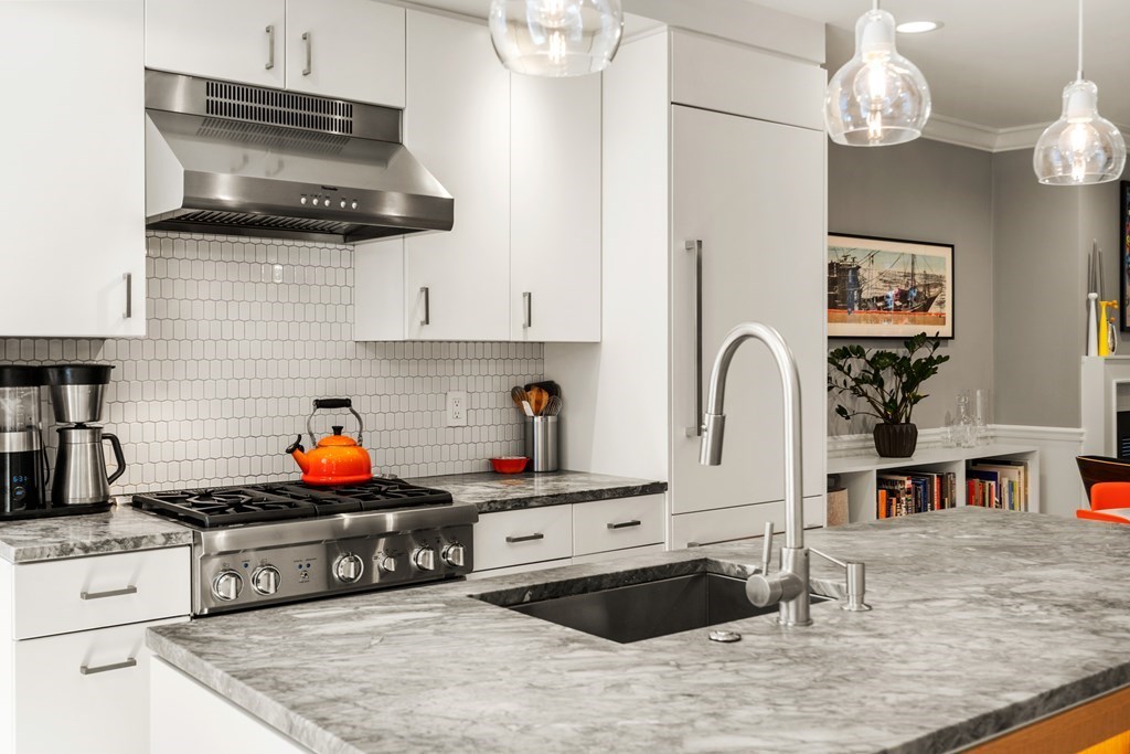 5 Auburn Street, Unit 1 Boston, MA 02129 - Photo 3 of 25 a kitchen with stainless steel appliances granite countertop a sink a stove and a wooden cabinets