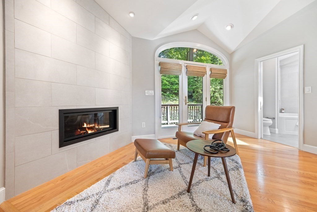 16 Marshall Road Winchester, MA 01890 - Photo 17 of 42 a living room with furniture a fireplace and a floor to ceiling window