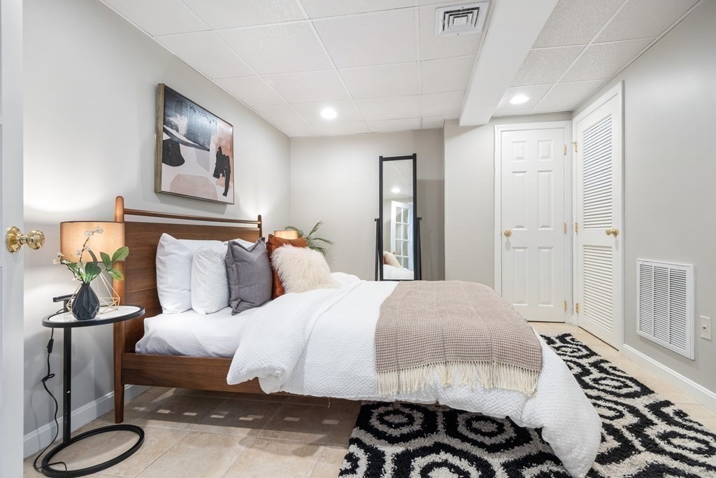 16 Marshall Road Winchester, MA 01890 - Photo 27 of 42 a bedroom with a bed and wooden floor