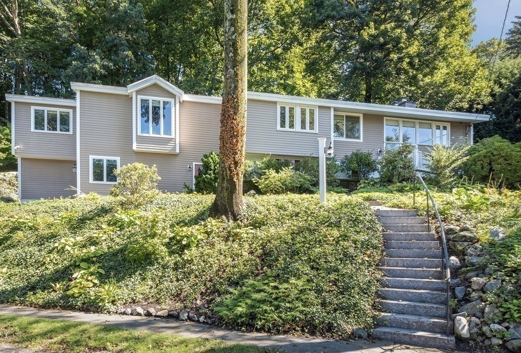 16 Marshall Road Winchester, MA 01890 - Photo 31 of 42 a front view of a house with a yard and potted plants