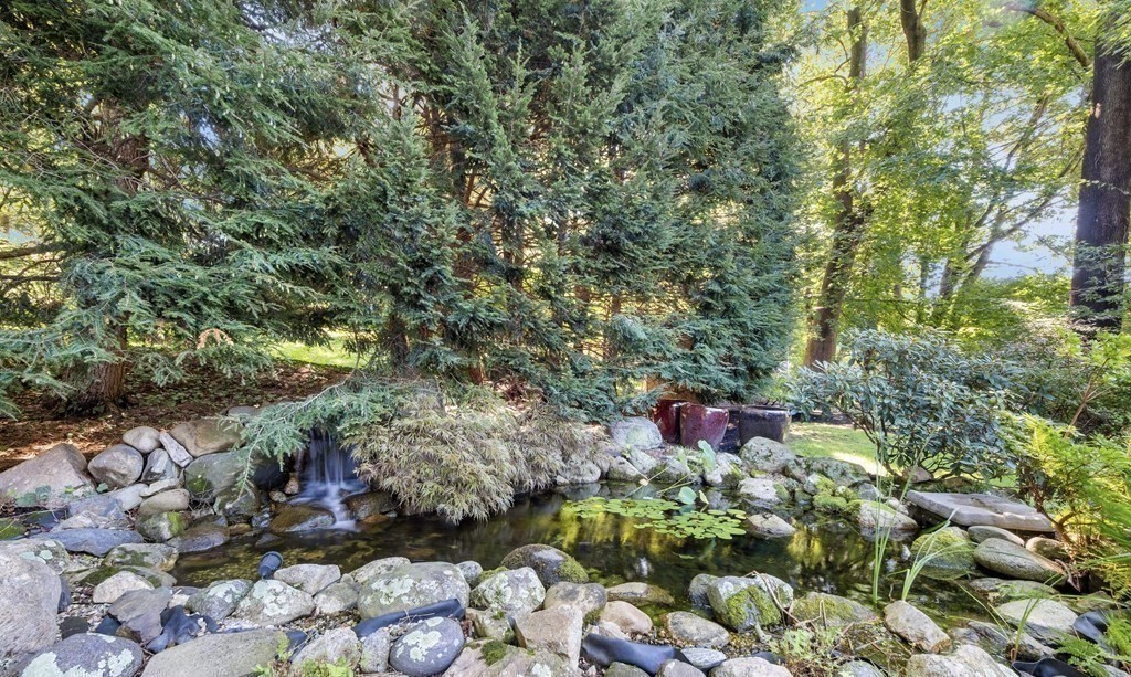 16 Marshall Road Winchester, MA 01890 - Photo 37 of 42 a backyard of a house with lots of green space