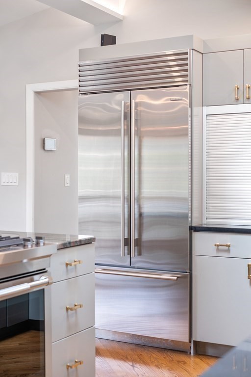 16 Marshall Road Winchester, MA 01890 - Photo 6 of 42 a kitchen with a refrigerator and a stove