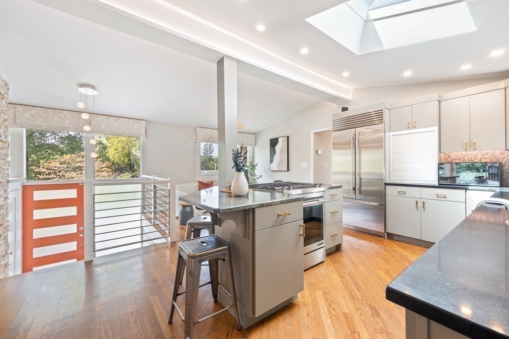 16 Marshall Road Winchester, MA 01890 - Photo 9 of 42 a kitchen with kitchen island a counter top space a sink stainless steel appliances and cabinets