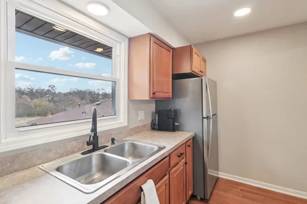 a kitchen with stainless steel appliances a sink and a refrigerator
