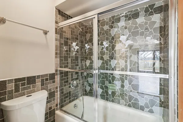 a bathroom with a shower and a toilet sink