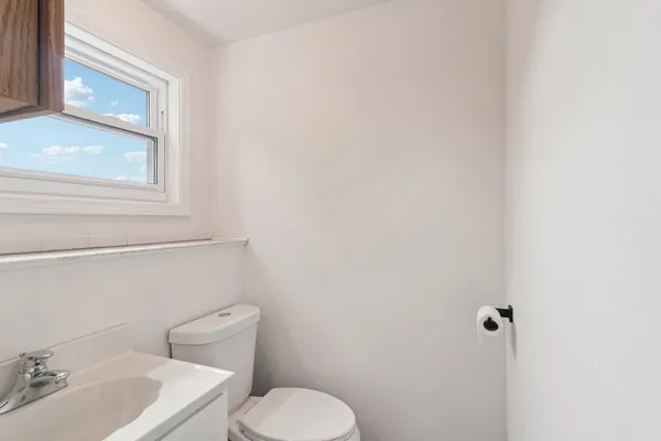 a white toilet sitting next to a bathroom sink