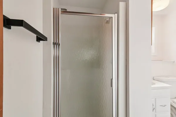 a bathroom with a glass shower door