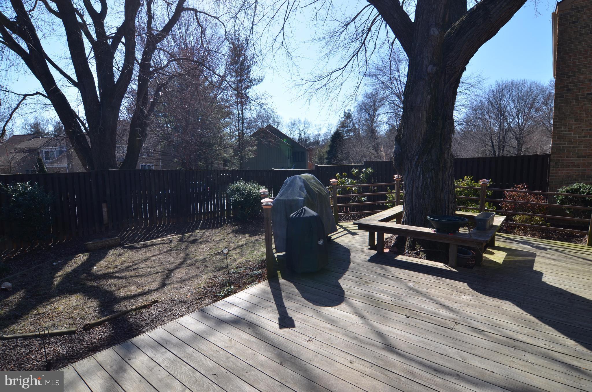 10801 Hunt Club Road Reston, VA 20190 - Photo 2 of 6 a view of backyard with table and chairs and wooden fence