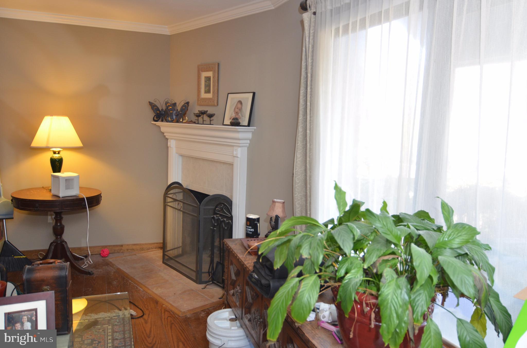 10801 Hunt Club Road Reston, VA 20190 - Photo 5 of 6 a living room with furniture a fireplace and a window