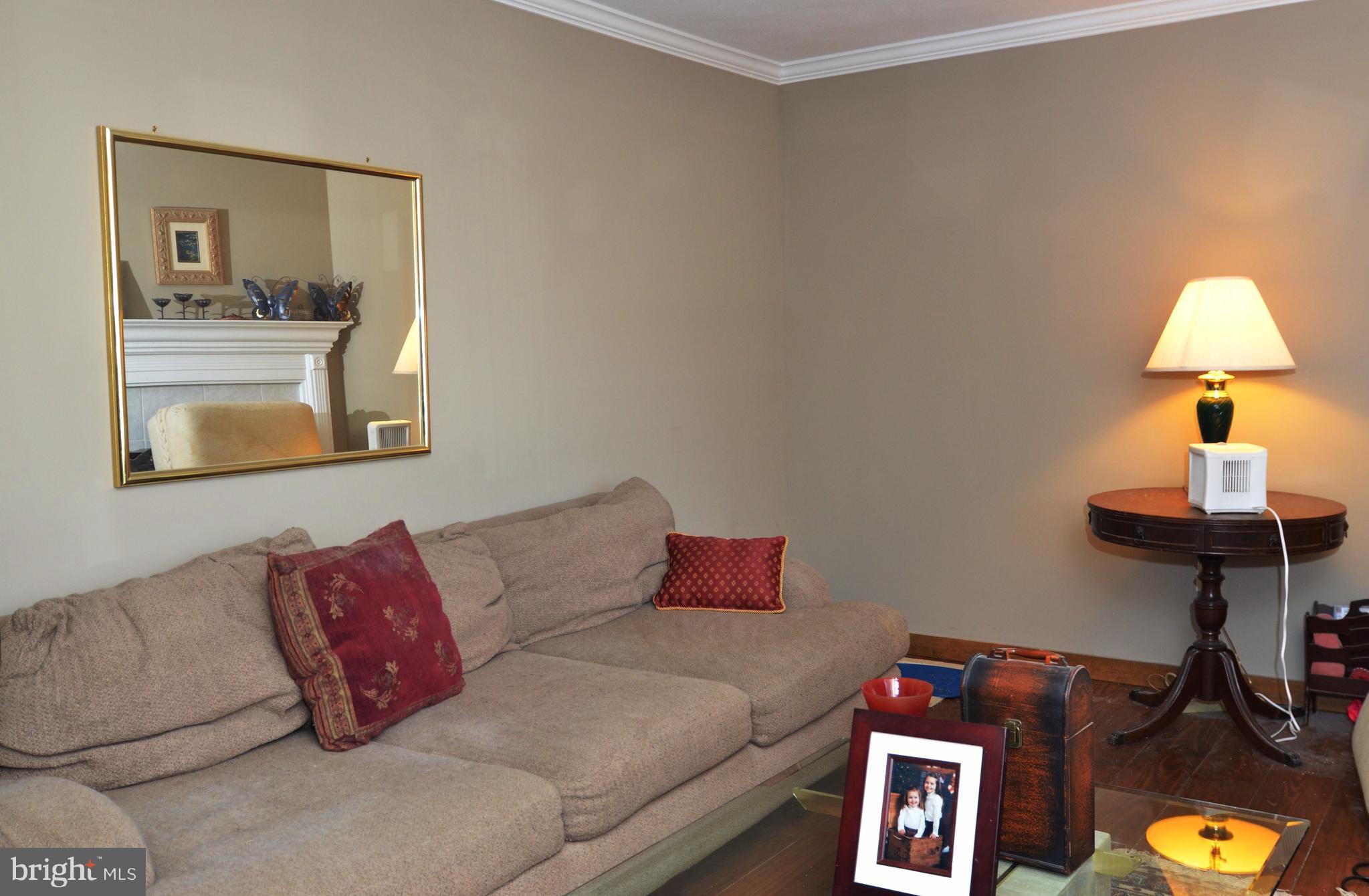 10801 Hunt Club Road Reston, VA 20190 - Photo 6 of 6 a living room with furniture and a lamp