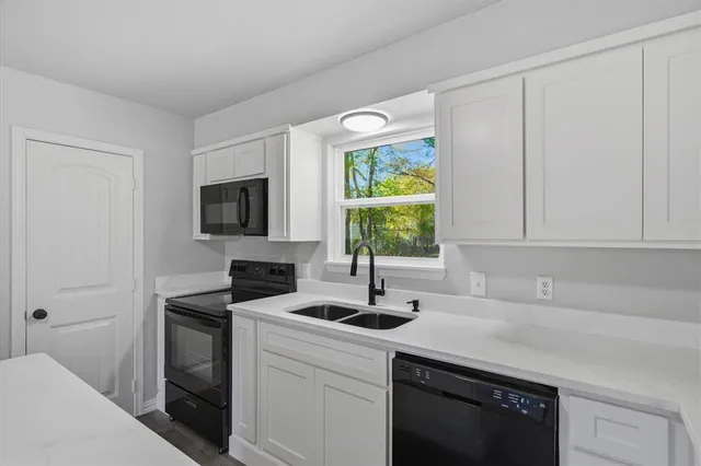 a kitchen with a sink stove and microwave