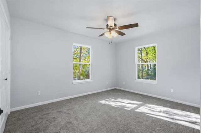 a view of room with window and ceiling fan