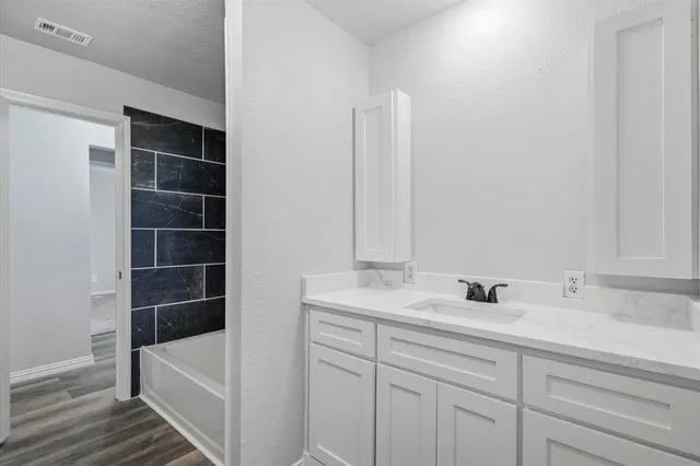 a bathroom with a sink and a large mirror