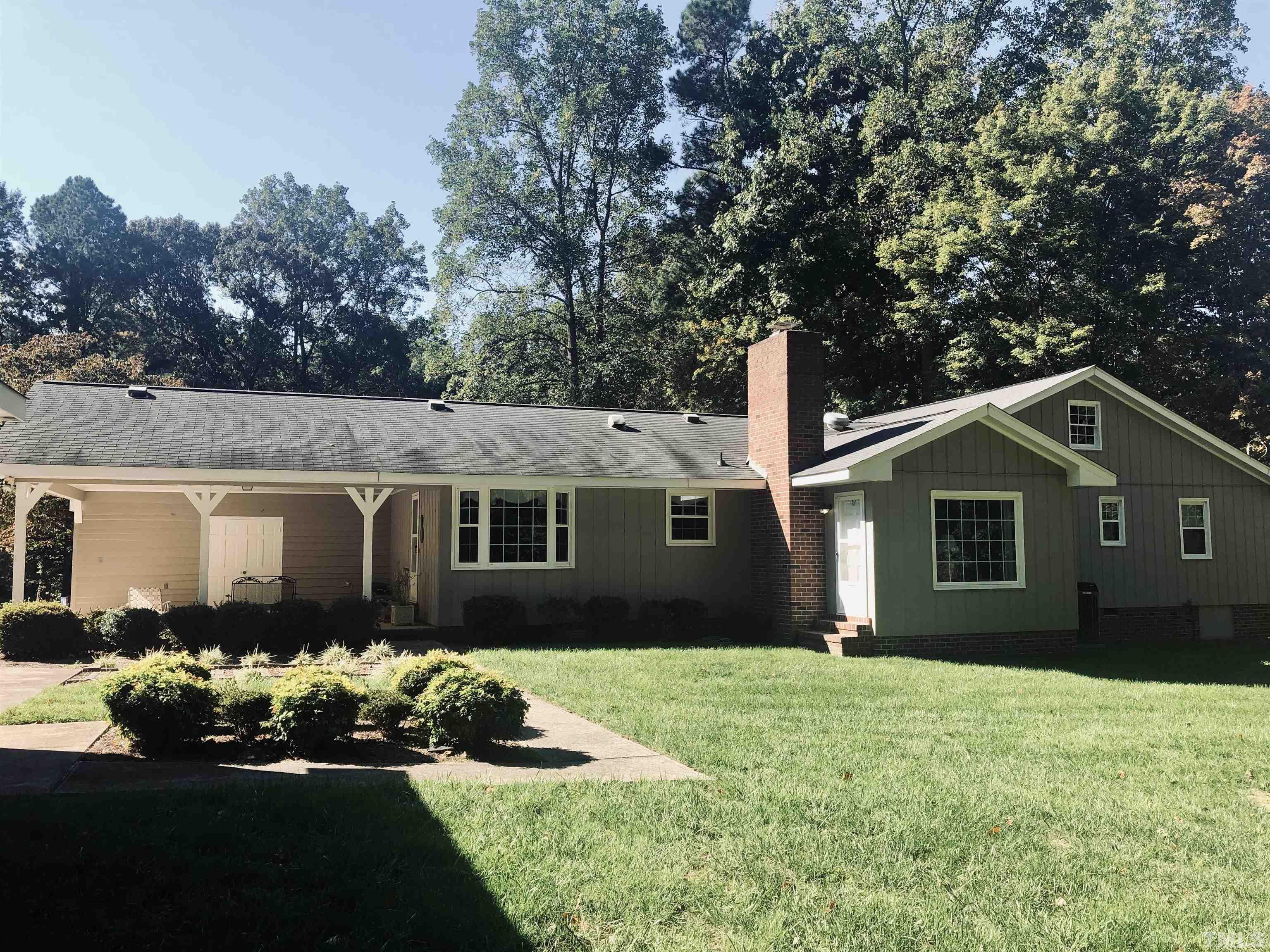 4909 Will-O-Dean Road Raleigh, NC 27616 - Photo 3 of 15 a front view of a house with a garden and trees