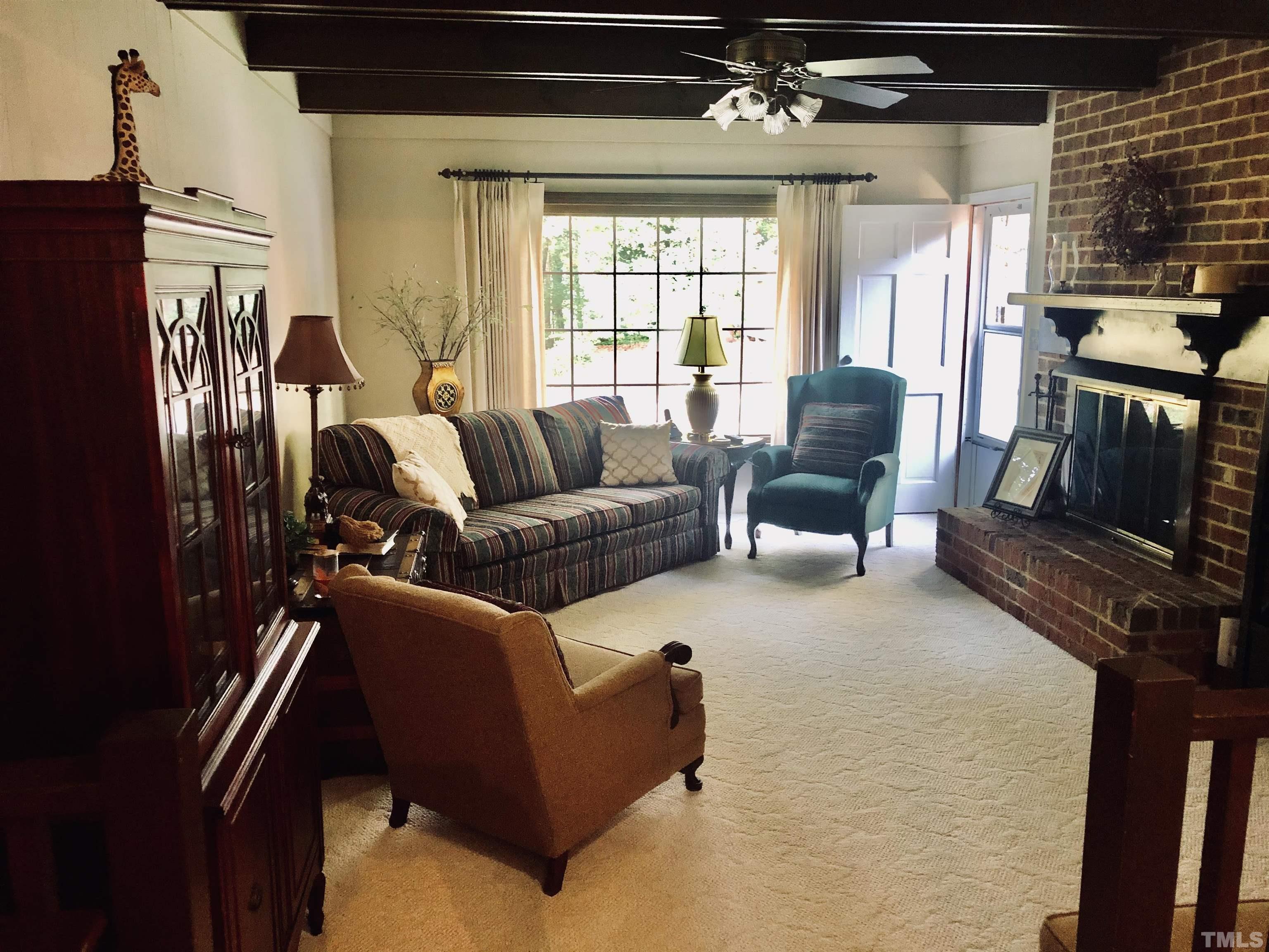 4909 Will-O-Dean Road Raleigh, NC 27616 - Photo 5 of 15 a living room with furniture windows and a fireplace